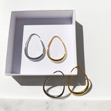 Golden and Silver Oval ear hoops, thin at the top and gradually thicker at the bottom for a beautiful large hoop effect